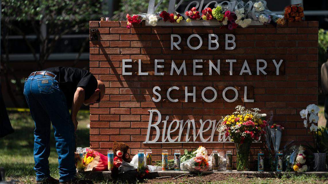 A law enforcement personnel lights a candle outside Robb Elementary School in Uvalde, Texas, Wednesday, May 25, 2022. Desperation turned to heart-wrenching sorrow for families of grade schoolers killed after an 18-year-old gunman barricaded himself in their Texas classroom and began shooting, killing third- and fourth-graders and their teachers. (AP Photo/Jae C. Hong)
