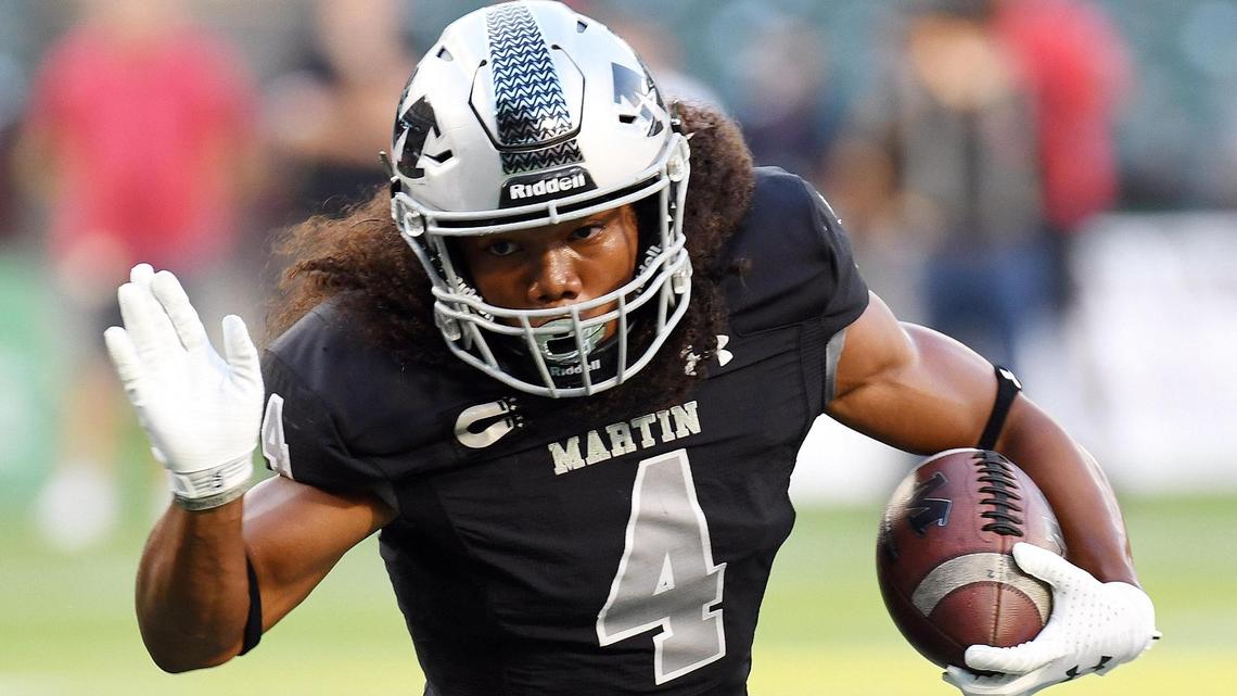 Arlington Martin’s Zaire Barrow, evades the Lake Travis defense for a touchdown. He scored four times.