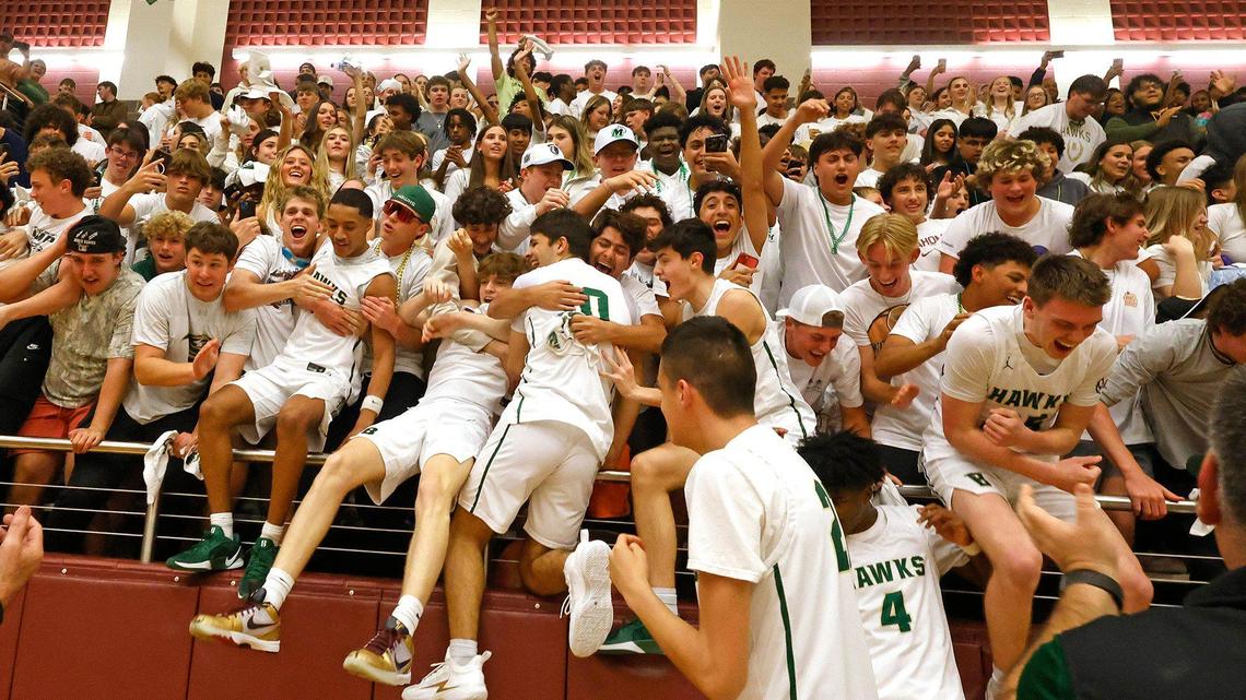 Hawk players jump into the stands with fans after winning the UIL 5A state semifinal playoff basketball playoff game at Lewisville High School in Lewisville Texas, Tuesday, Mar. 04, 2025.