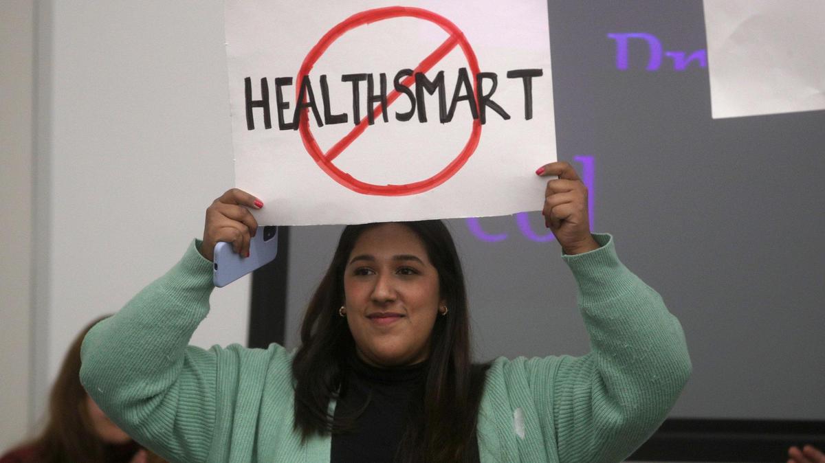 Valeria Nevarez, 22, holds a sign to protest the HealthSmart sexual education curriculum during a school board meeting in January. The district is not offering sex education this year after parents pushed back on plans to start the HealthSmart program.