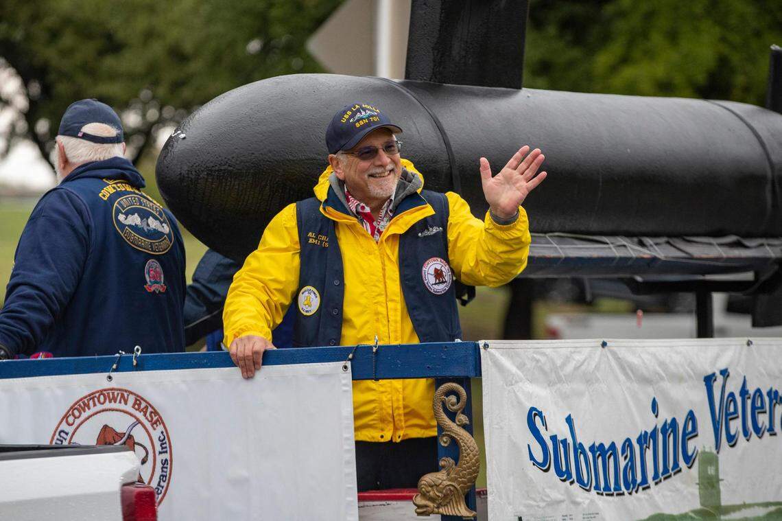 Members of the The United States Submarine Veterans, Inc. wave to attendants of the Veterans Day Parade winding through Fort Worth on Friday, Nov. 11, 2022. Despite rain, hundreds of participants marched down North Forest Park Boulevard, waving American flags and signing a medley of military songs.