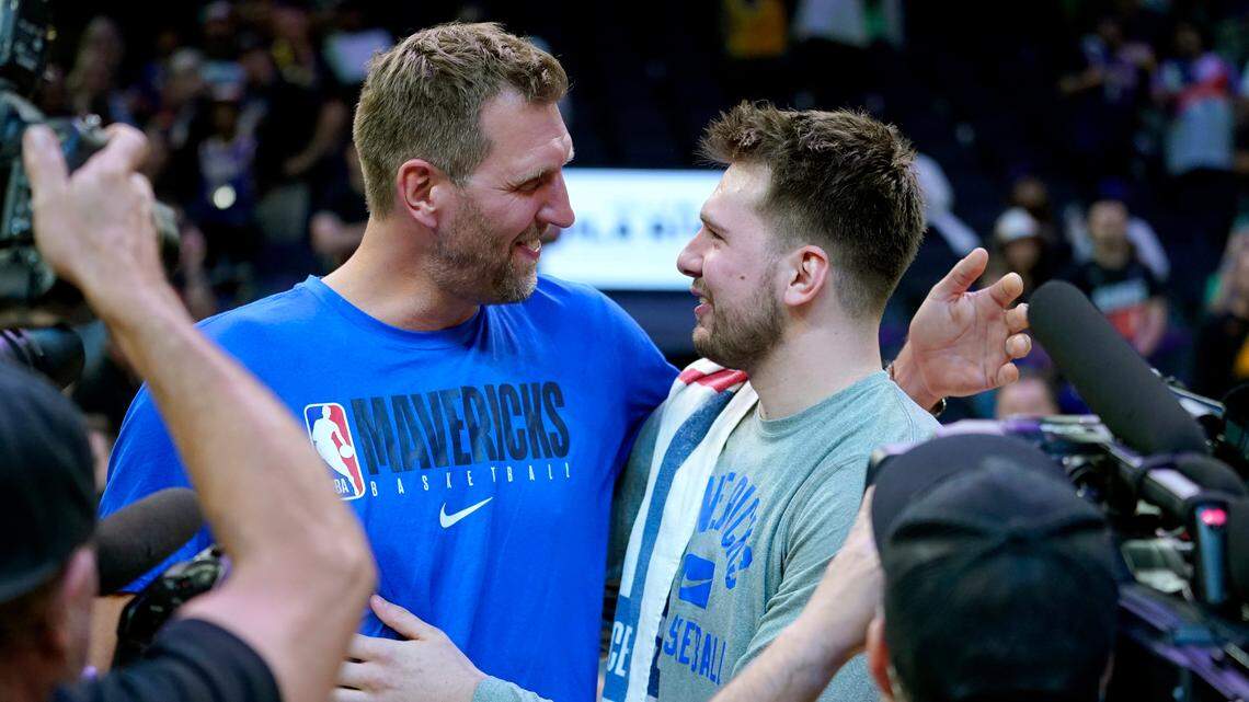 Dallas Mavericks guard Luka Doncic , right, embraces former Dallas Maverick Dirk Nowitzki after Game 7 of an NBA basketball Western Conference playoff semifinal against the Phoenix Suns, Sunday, May 15, 2022, in Phoenix. The Mavericks defeated the Suns 123-90. (AP Photo/Matt York)