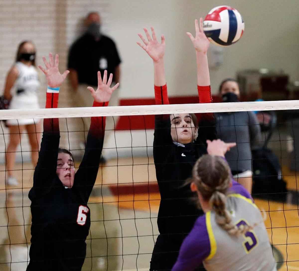 Martin’s Courtney Hanson and Emily Adams attempt to block the shot of Granbury’s Courtney Smith during a high school volleyball match at Martin High School in Arlington, Texas, Tuesday, Sept. 29, 2020. Martin Lady Warriors defeated the Granbury Lady Pirates in three straight sets. (Special to the Star-Telegram Bob Booth)