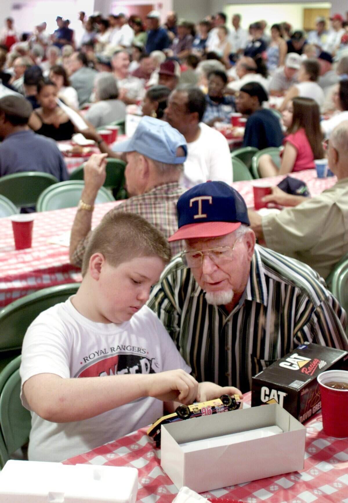 Sept. 3, 2001: Terry Creamier, 11, of Arlington examines a model car with his grandfather, J.C. Tow, 78. Terry won the toy in a raffel at the AFL/CIO annual Labor Day picnic held at the UAW Hall in Hurst.