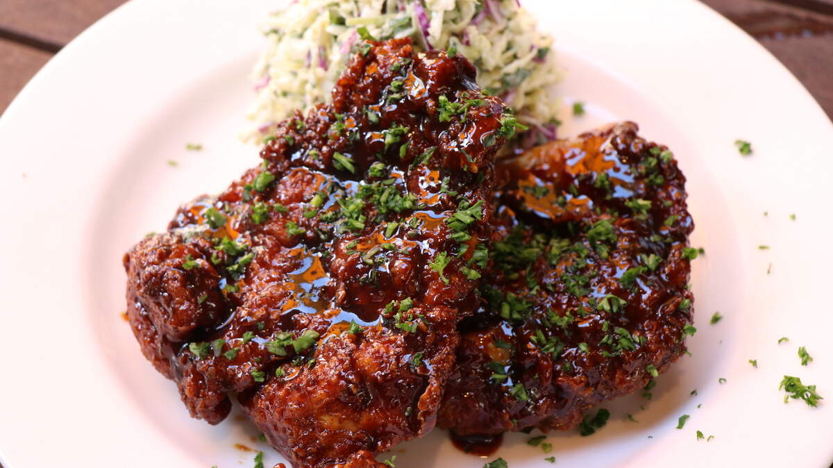 No-Never™ Hot Chicken at Doc B’s Fresh Kitchen: half of a fully deboned spatchcock chicken fried and tossed in a house-made habanero honey glaze and paired with creamy coleslaw.