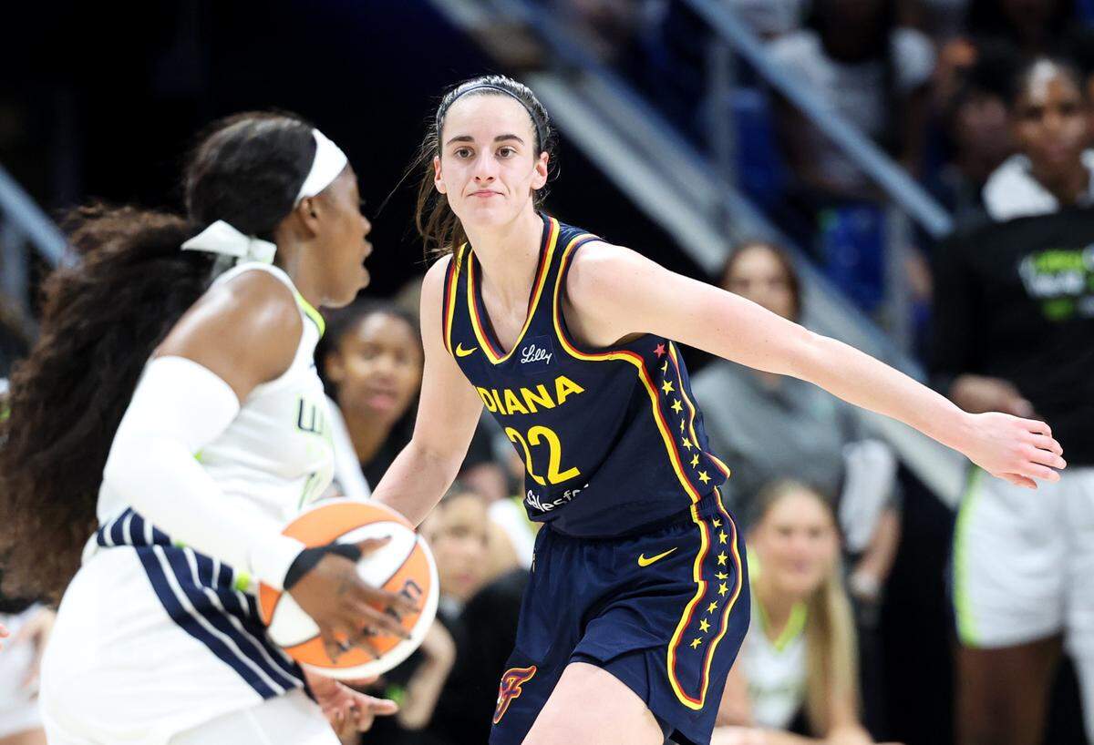 May 3, 2024; Dallas, Texas, USA; Indiana Fever guard Caitlin Clark (22) defends Dallas Wings guard Arike Ogunbowale (24) during the game at College Park Center. Mandatory Credit: Kevin Jairaj-USA TODAY Sports