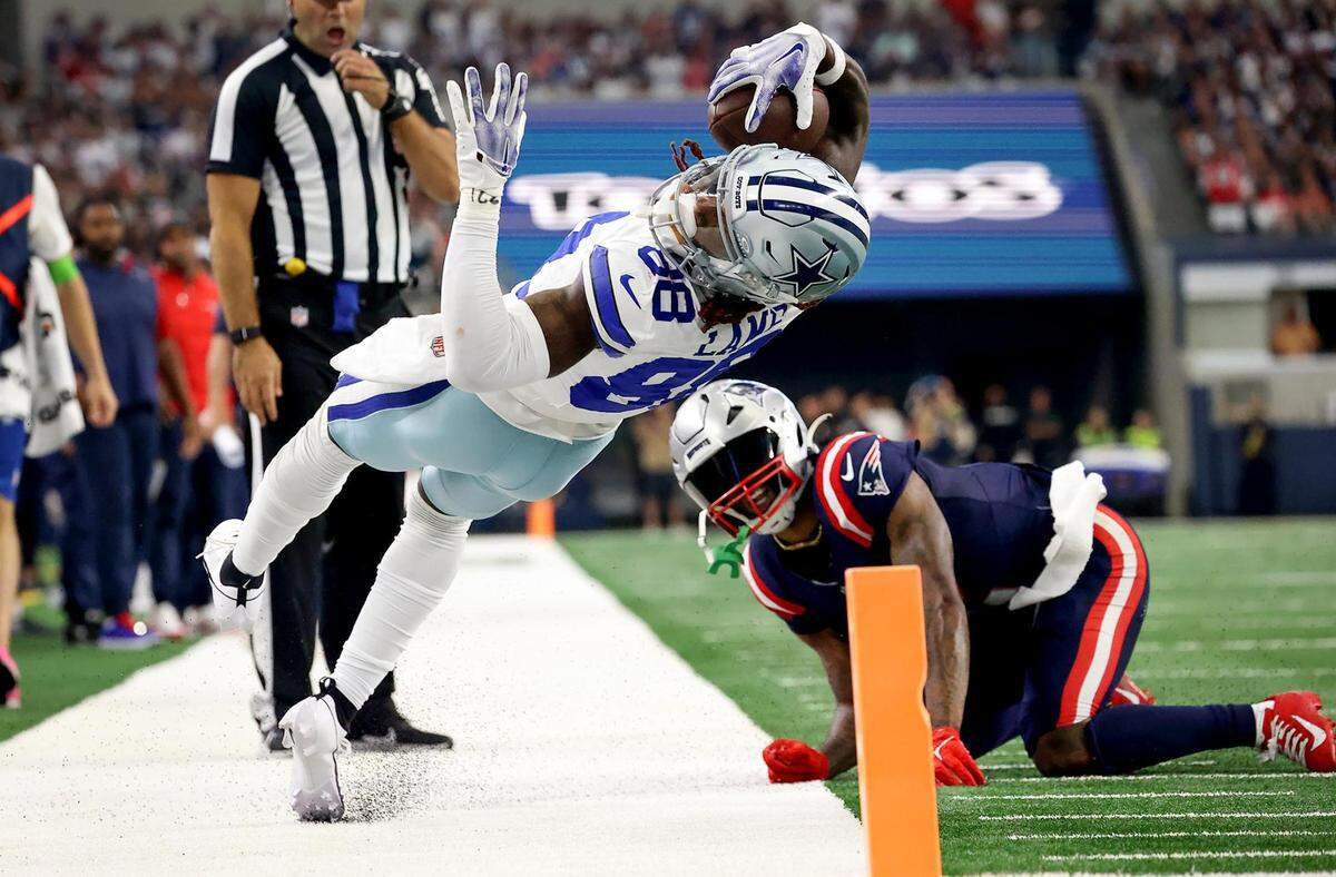 Dallas Cowboys wide receiver CeeDee Lamb attempts to stretch into the end zone while competing against the New England Patriots on Sunday, October 1, 2023, at AT&T Stadium in Arlington.