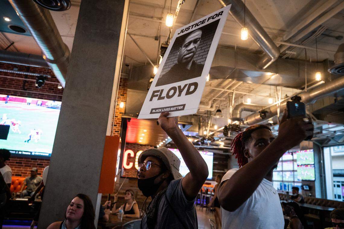 Protesters demanding an end to police brutality march through Concrete Cowboy bar Monday, June 8, 2020, in Fort Worth.