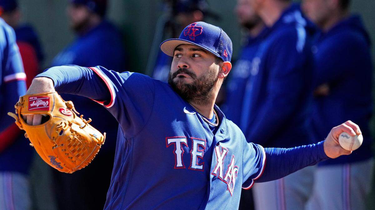 Texas Rangers pitcher Martin Perez throws during spring training baseball practice Wednesday, Feb. 15, 2023, in Surprise, Ariz. (AP Photo/Charlie Riedel)