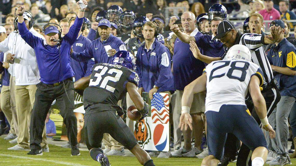 TCU coach Gary Patterson celebrates Travin Howard's interception against West Virginia during a game in 2015. Howard led the Frogs in tackles from 2015 to 2017.
