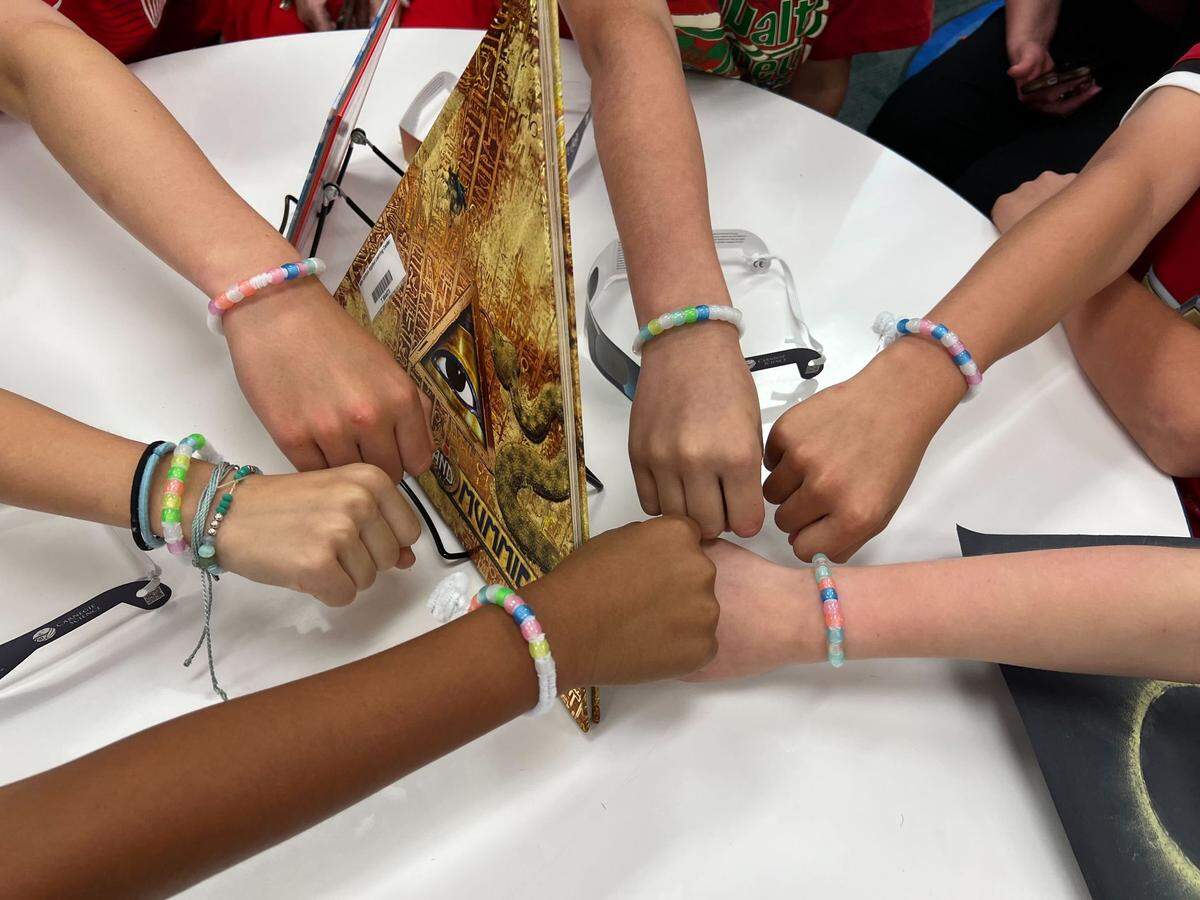 Fifth-grade students at Alice Carlson Applied Learning Center in Fort Worth who helped organize lesson plans and activities for the school in preparation for the solar eclipse show off their “UV bracelets” on Monday, April 8, 2024. The colors of the beads are supposed to get brighter in the sunlight and serve as a visual indicator that the eclipse is happening. The beads should turn less bright when the moon blocks the sun.