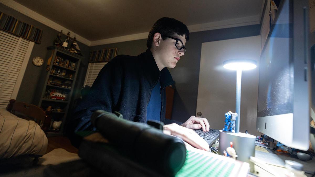 High school sophomore Andrew James, 16, logs on to his computer in his room at his family residence in Fort Worth on Dec. 12. When he was younger, James struggled with reading due to living with dyslexia. When his mother withdrew him from Fort Worth ISD and transferred him to Key School and Training Center, she noticed drastic changes in his reading habits and self-confidence.