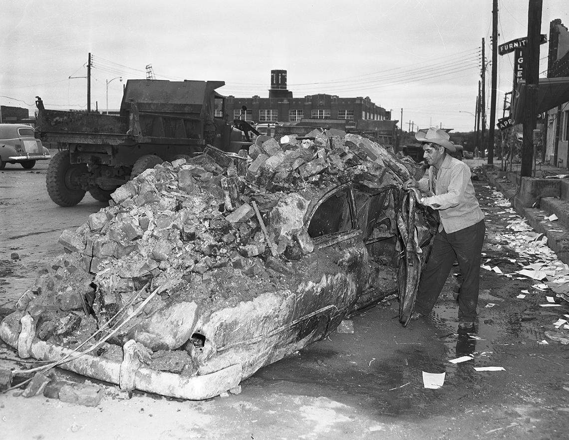 Nick Tusa, owner of Nick’s Fish Market on East Second Street in Waco, left this car seconds before a tornado struck in 1953. Power lines set fire to the car and bricks from his market crashed down on it. Tusa, who sought cover in his market, escaped from his business by pushing through debris.