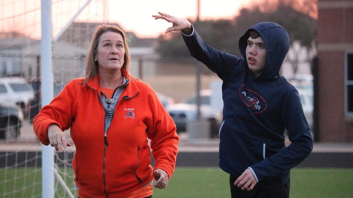 Assistant coach Mandy Overturff helps an athlete during a recent practice for the Aledo Special Olympics team.