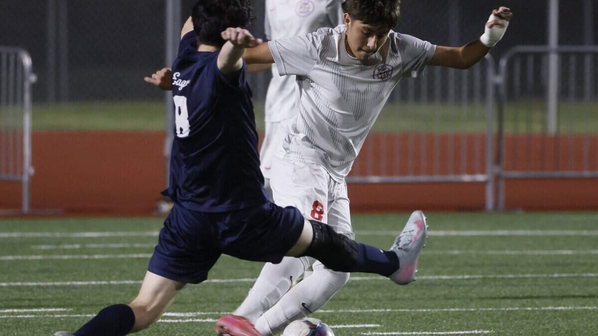 Allen defender Andres Lopez (8) attempts to block the pass by Arlington Sam Houston Jose Rubio (8) during the second half of a UIL area round boys soccer playoff game at Tommy Standridge Stadium in Carrollton, Texas, Tuesday, March 24, 2026.