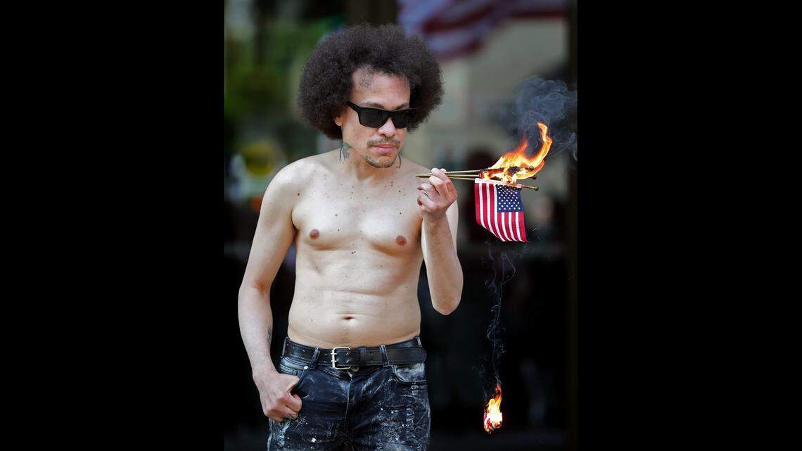 A demonstrator burns American Flags during a May march in Akron, Ohio, to protest a police shooting.