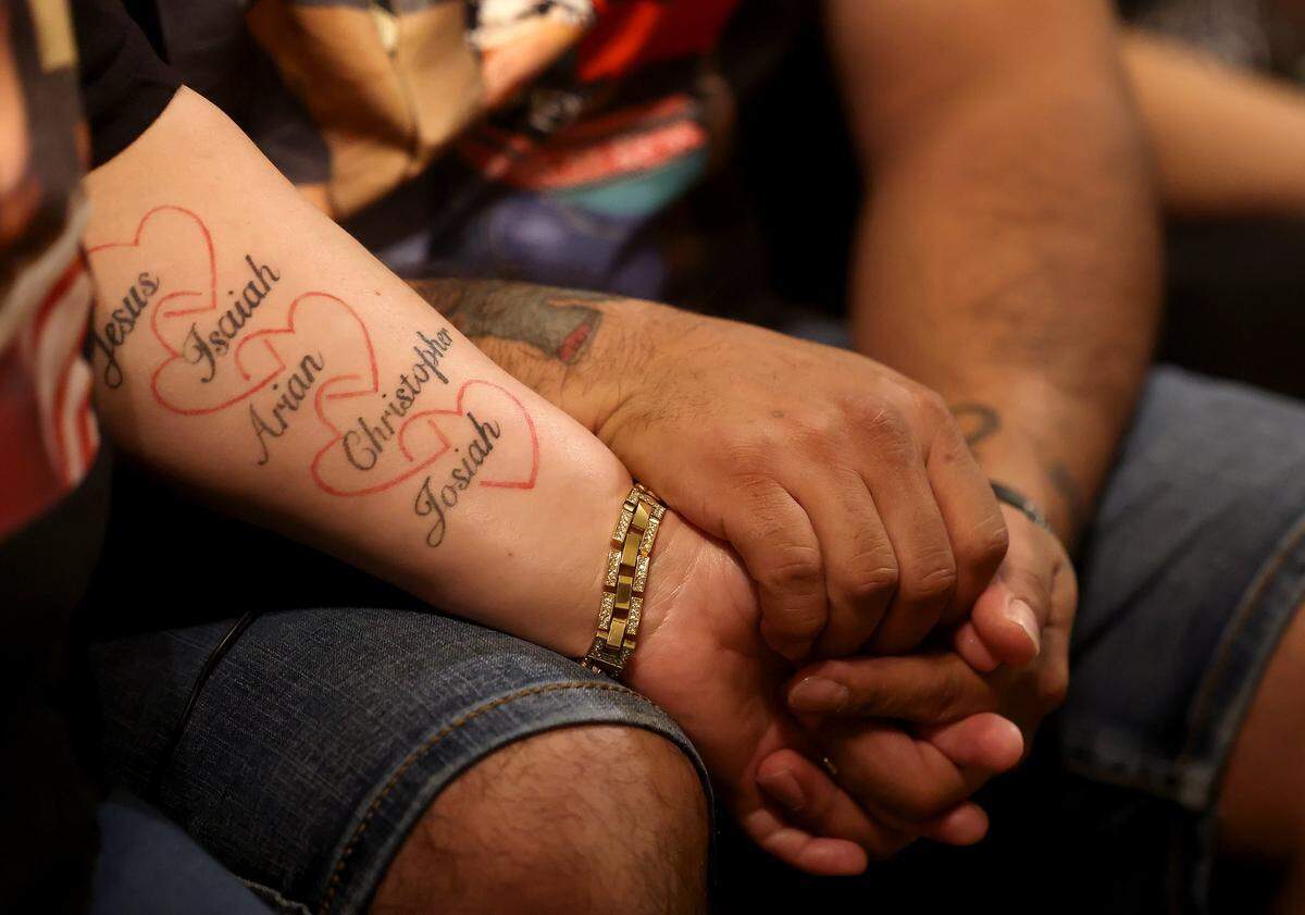 Irma and Jesus Manuel Gonzalez hold hands while talking about their son, Jesus, 17, who was killed in a a suspected drunk-driving crash. The names of her five sons run the length of Irma Gonzalez's forearm.
