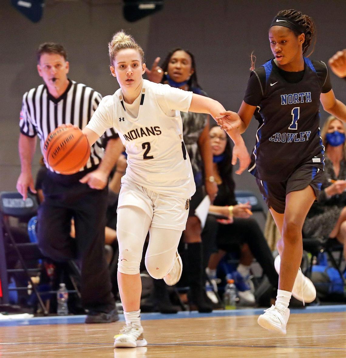 Keller guard Cambridge Mathews (2) heads to the paint chased by North Crowley guard Alaina Payne (1) during the second half of a Division 6A Region 1 quarterfinal basketball game at Arlington ISD Complex in Arlington, Texas, Thursday, Feb. 25, 2021. Keller defeated North Crowley 76-66. (Special to the Star-Telegram Bob Booth)