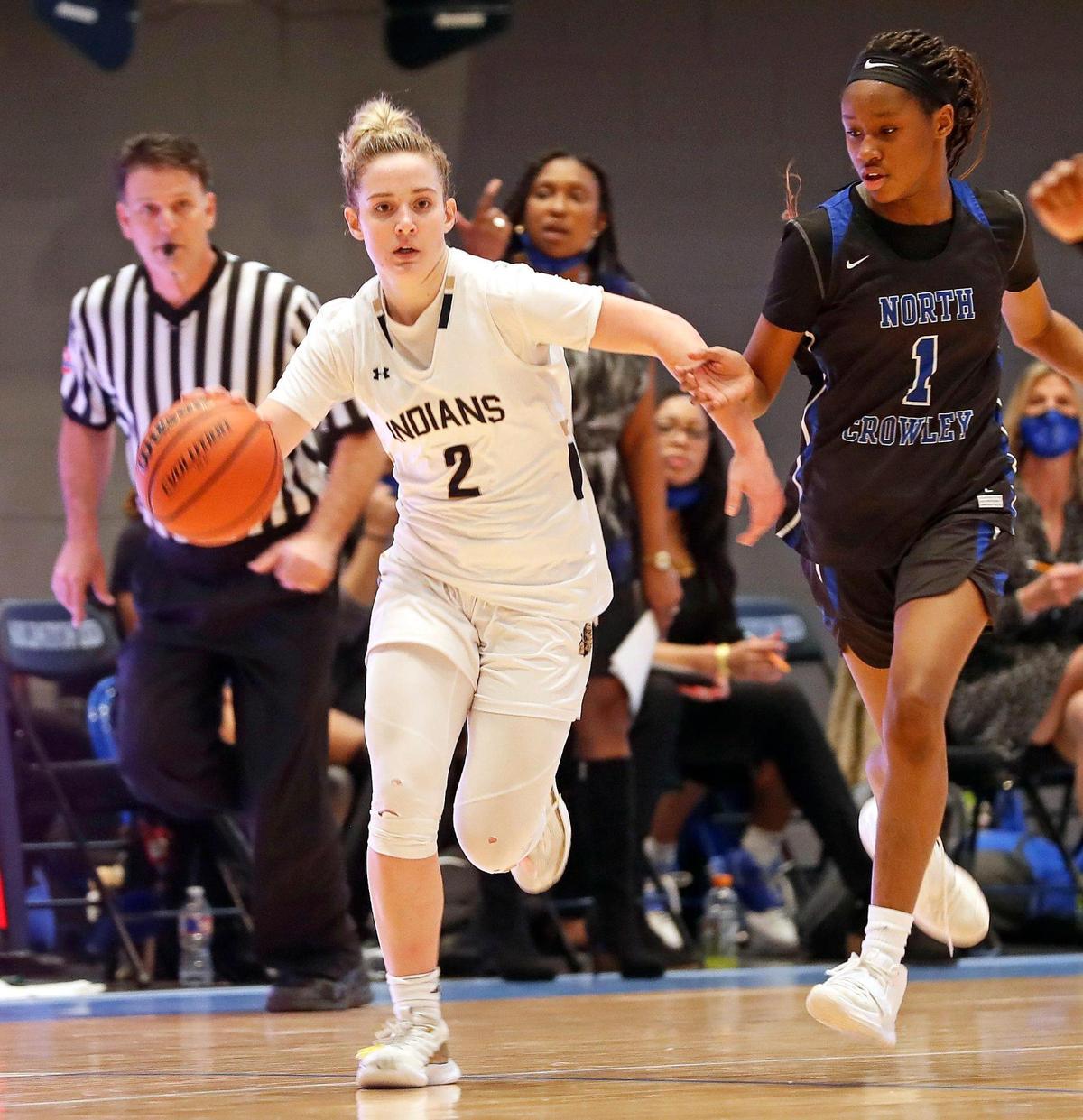 Keller guard Cambridge Mathews (2) heads to the paint chased by North Crowley guard Alaina Payne (1) during the second half of a Division 6A Region 1 quarterfinal basketball game at Arlington ISD Complex in Arlington, Texas, Thursday, Feb. 25, 2021. Keller defeated North Crowley 76-66. (Special to the Star-Telegram Bob Booth)