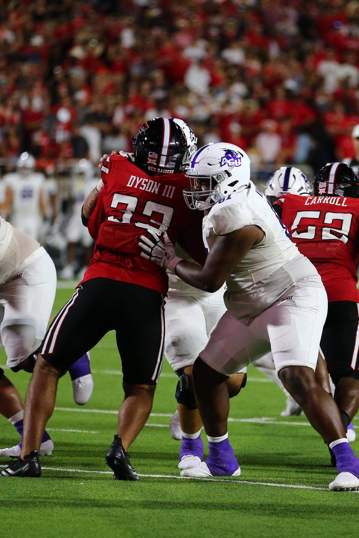 Aug 31, 2024; Lubbock, Texas, USA; Abilene Christian Wildcats offensive tackle Dylan Kinney (61) blocks Texas Tech Red Raiders defensive linebacker Harvey Dyson III (33) in the second half at Jones AT&T Stadium and Cody Campbell Field. Mandatory Credit: Michael C. Johnson-USA TODAY Sports