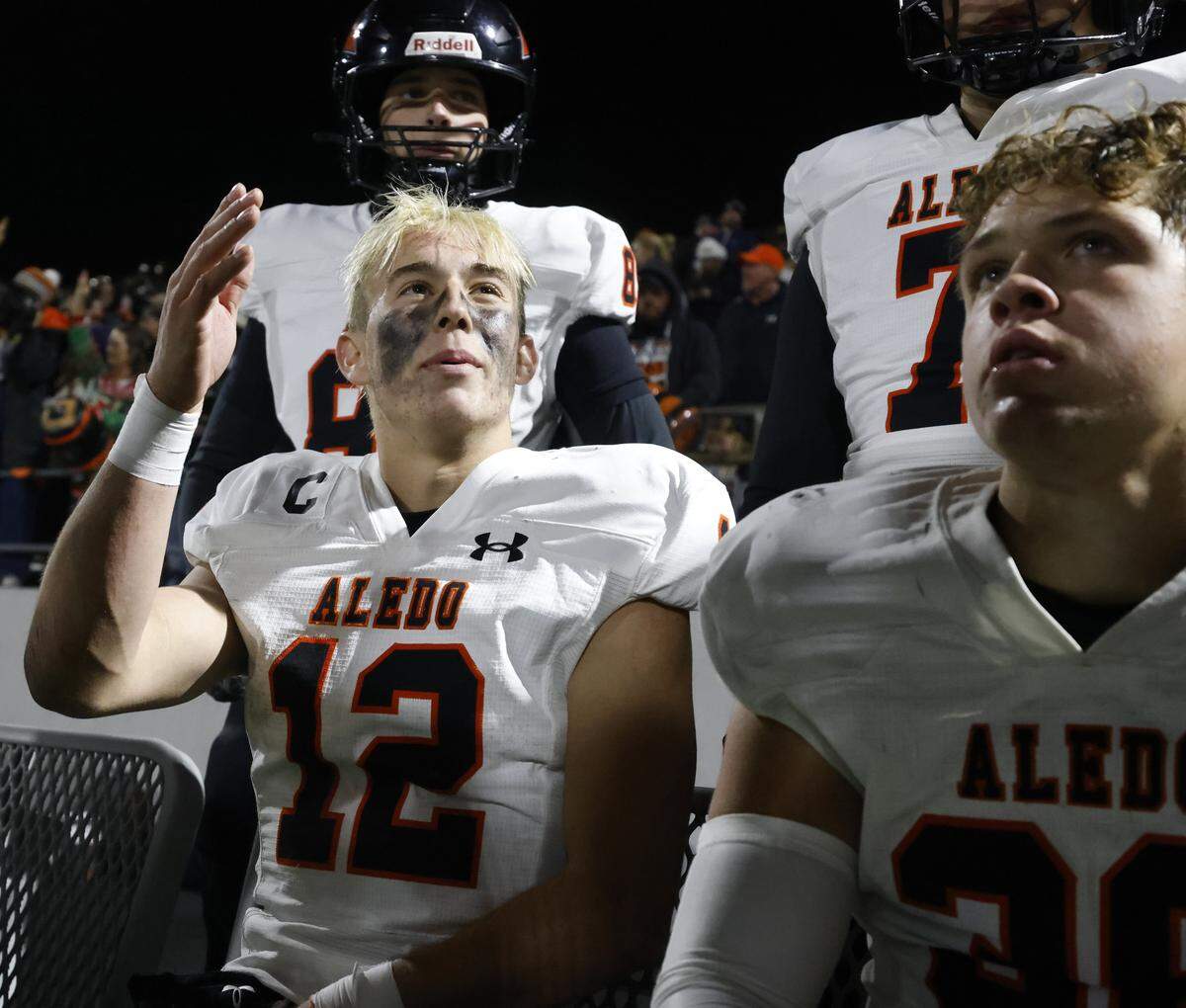 Aledo quarterback Lincoln Tubbs (12) talks with team mates while the defense is on the field during the second half of a UIL Class 5A Division I Quarterfinal on Friday Dec. 05, 2025 at Northwest ISD Stadium in Fort Worth, Texas.