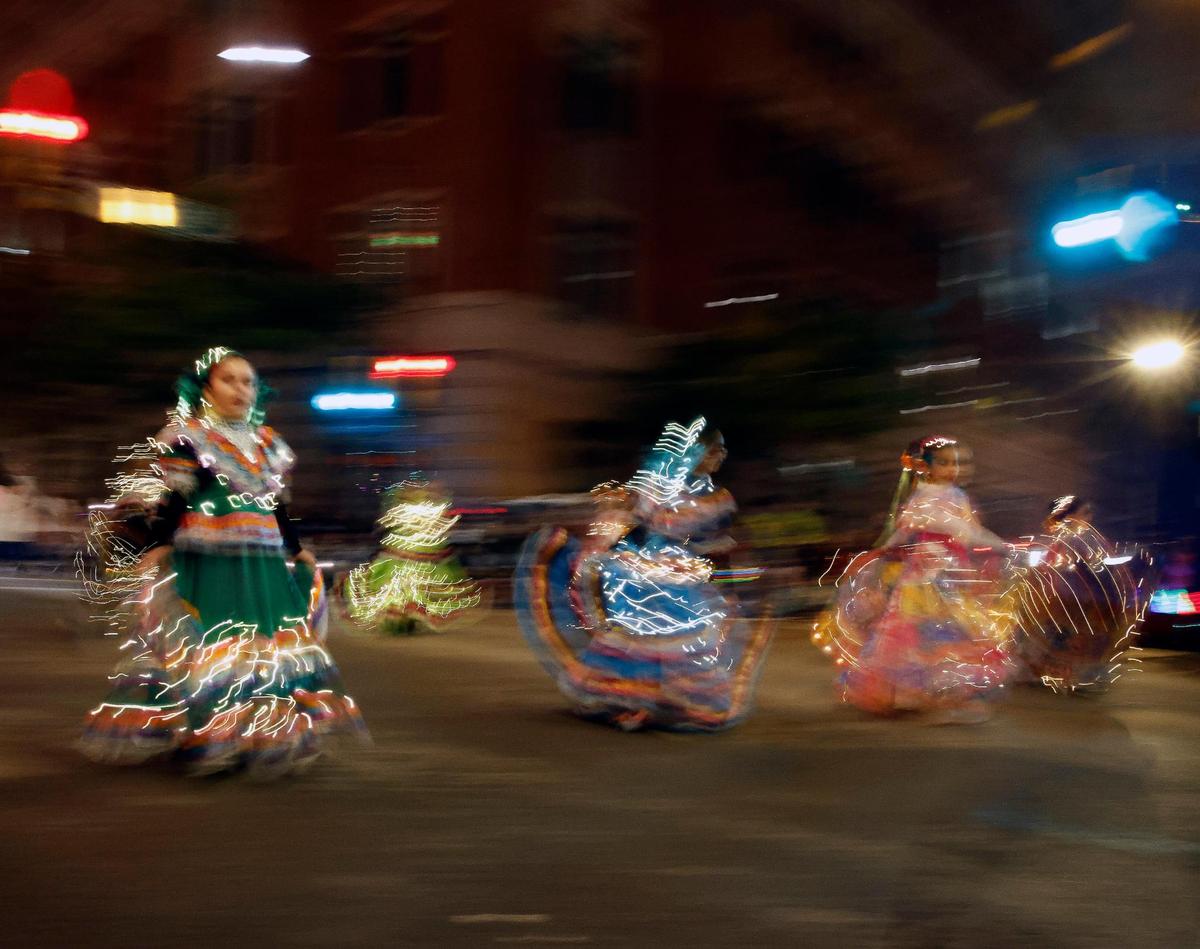 Dancers from Ballet Folklorico Quetzal pass down Commerce Street during the 2023 GM Financial Parade of Lights.