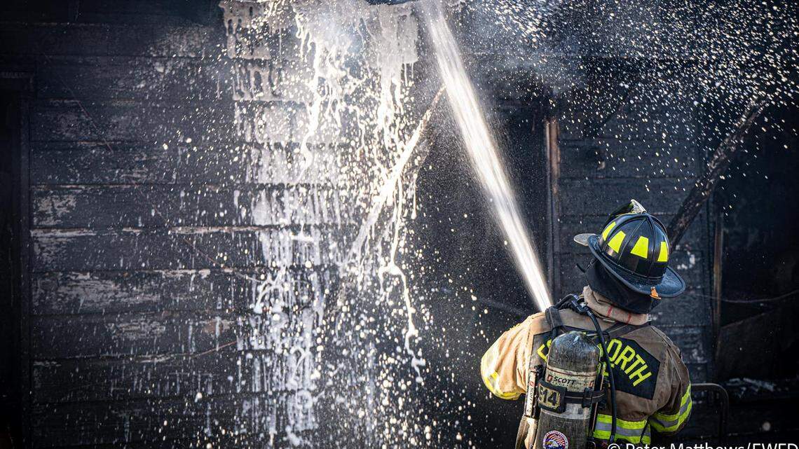 A Fort Worth firefighter battles a blaze at a residence in the 4600 block of Shackleford Street in east Fort Worth on Dec. 31, 2025. A Fort Worth firefighter battles a blaze at a residence in the 4600 block of Shackleford Street in east Fort Worth on Dec. 31, 2025.