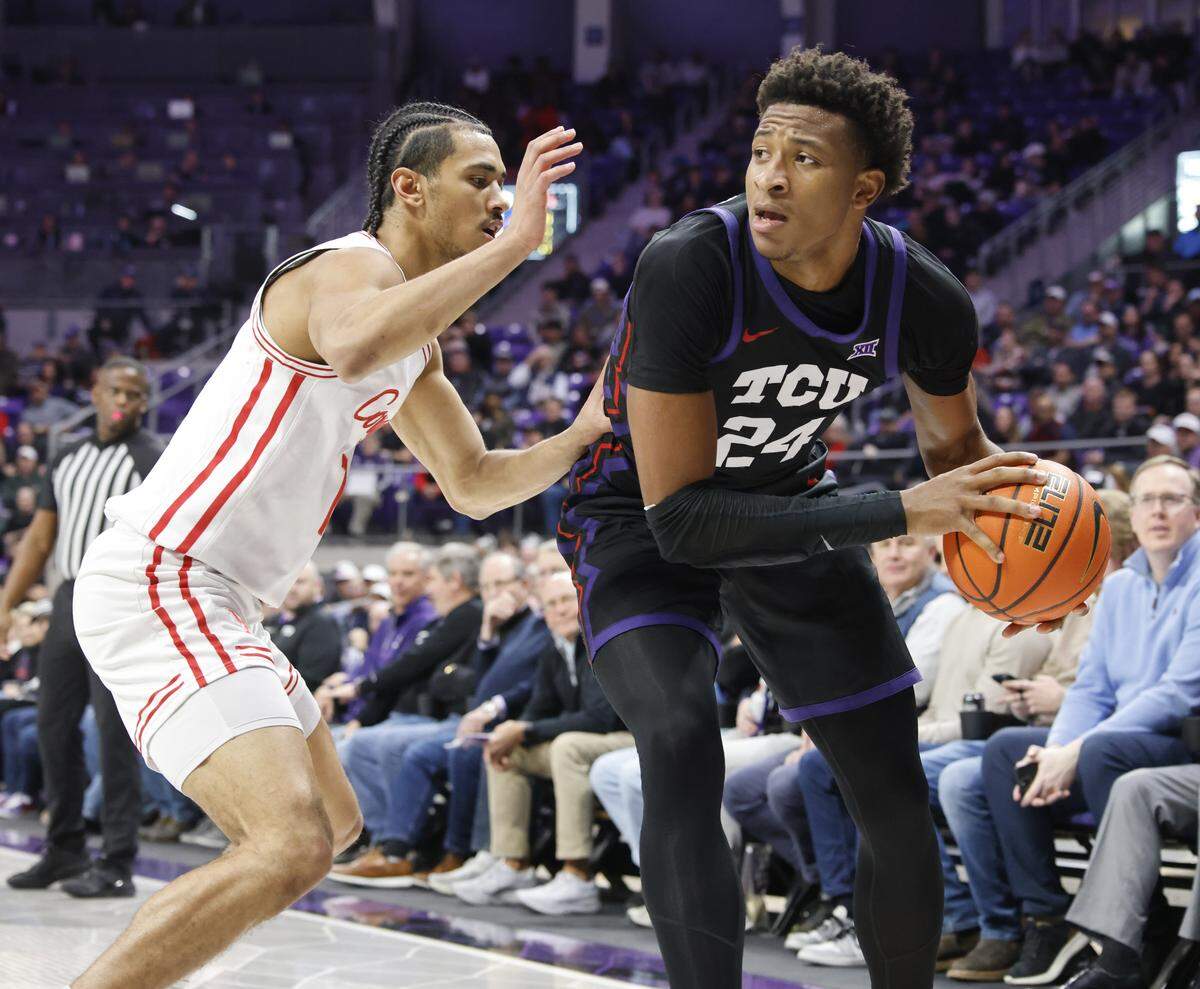 Houston guard Milos Uzan (7) gets TCU forward Xavier Edmonds (24) in the corner during the first half of a NCAA basketball game between the University of Houston and TCU at Schollmaier Arena in Fort Worth, Texas, Wednesday Jan. 26, 2026