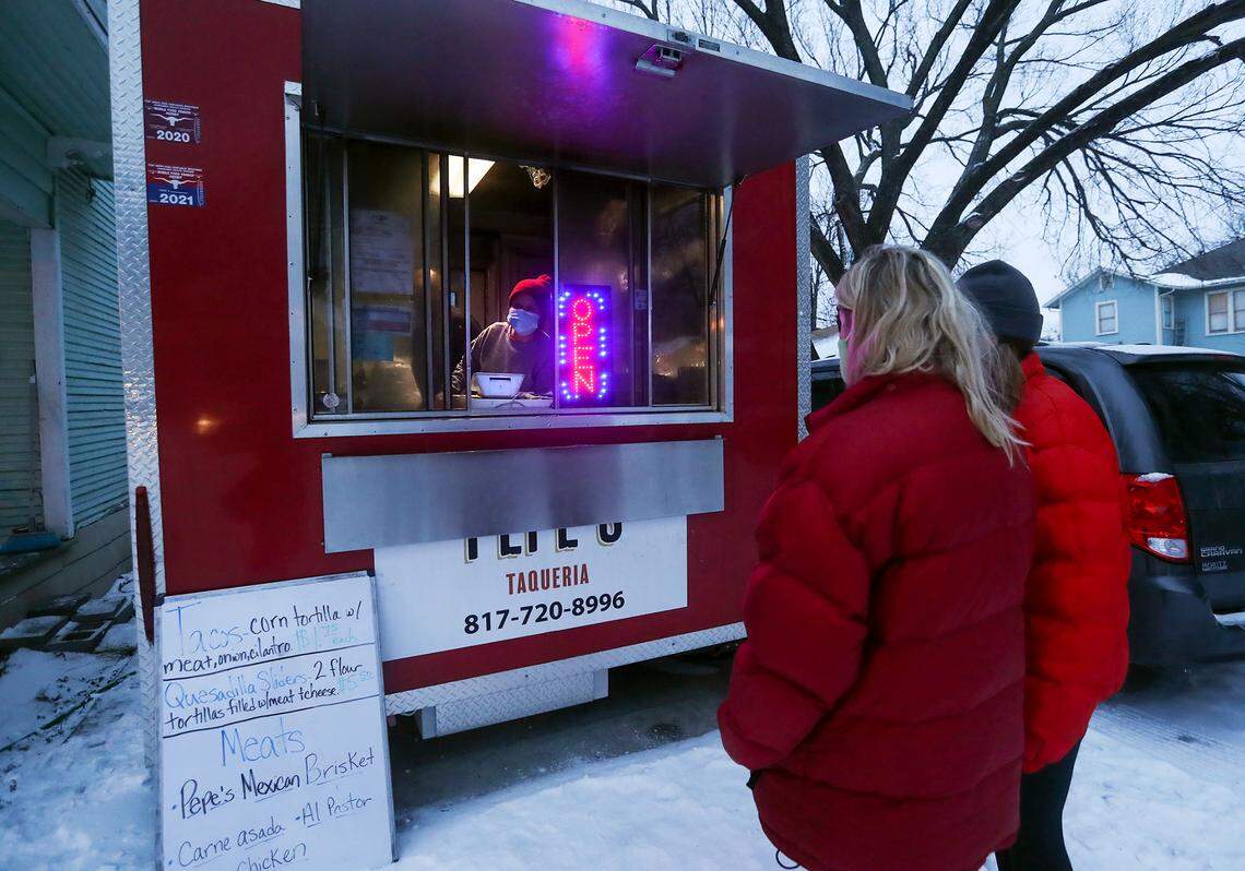 Leti Saldivar calls out an order from the food truck Pepe’s Taqueria in the Fairmount neighborhood on Feb. 17, 2021. Saldivar said she set up the popup outside of her home to serve tacos to the neighborhood as winter weather continues in North Texas.