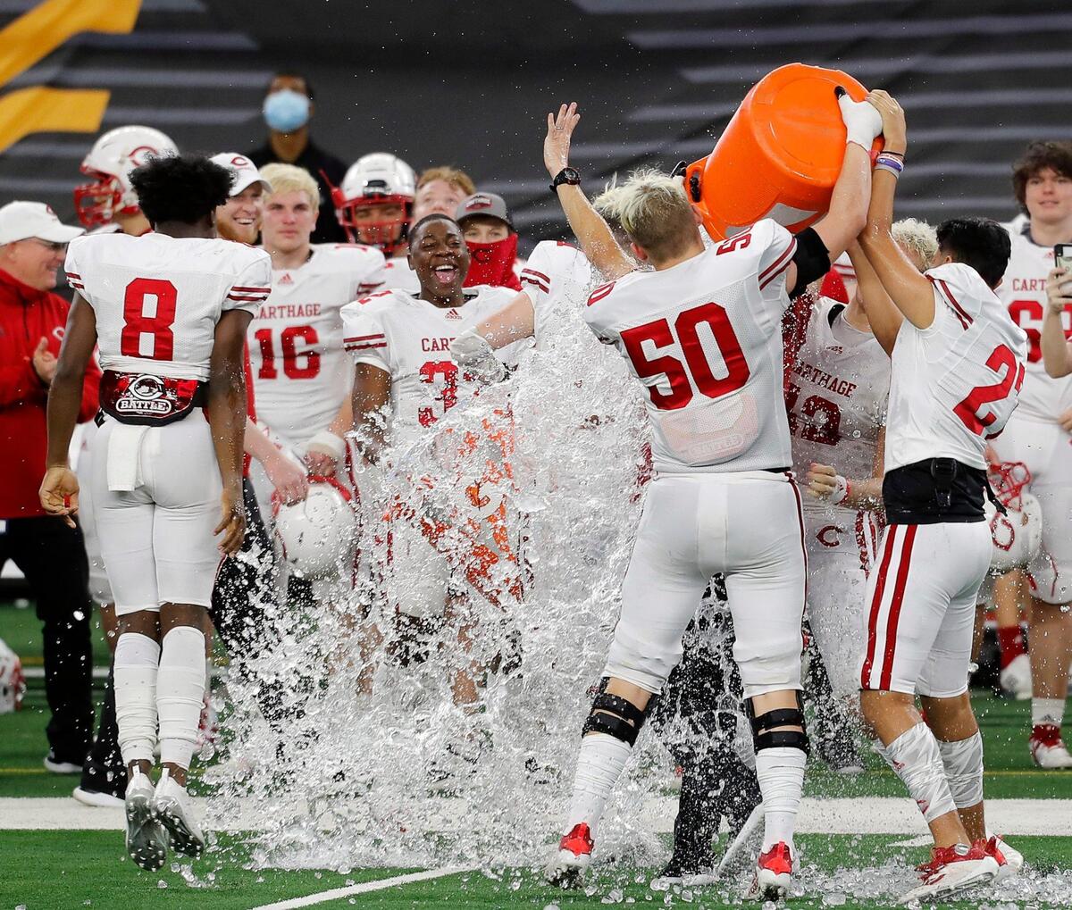 The Bulldogs give Carthage head coach Scott Surratt a congratulatory bath after a Conference 4A Division 2 State Championship football game at AT&T Stadium in Arlington, Texas, Friday, Dec. 18, 2020. Carthage won their eighth state championship in 14 years defeating Gilmer 70-14. (Special to the Star-Telegram Bob Booth)