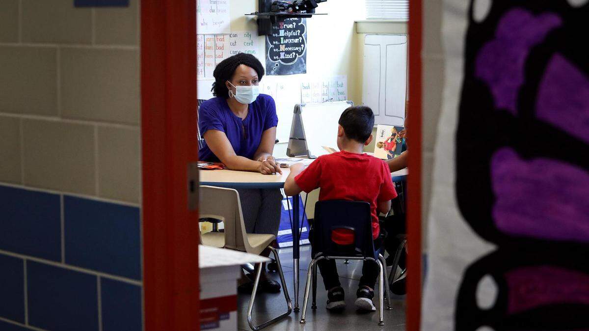 In this file photo, Tequila Lockridge, a leveled literacy interventionist at UCC Polytechnic Center, center, leads a small group of students through a Leveled Literacy Intervention session on Tuesday, July 13, 2021, in Fort Worth. The Fort Worth school board Tuesday approved its budget for the 2022-23 school year, which included pay raises for teachers and other employees.