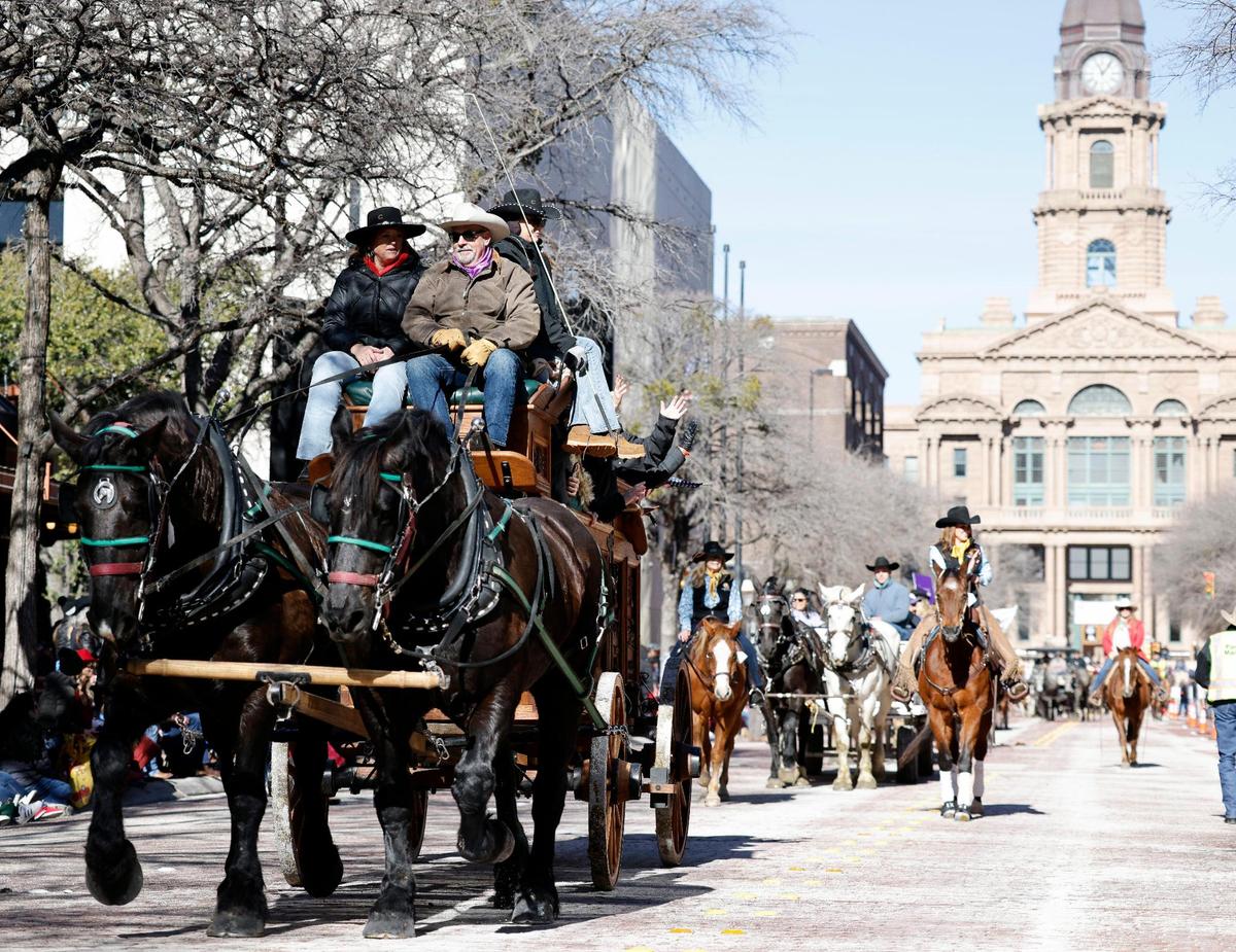 The Cowgirl Hall of Fame wagon makes its way down Main Street during the Fort Worth Stock Show & Rodeo parade in Fort Worth on Jan. 13.