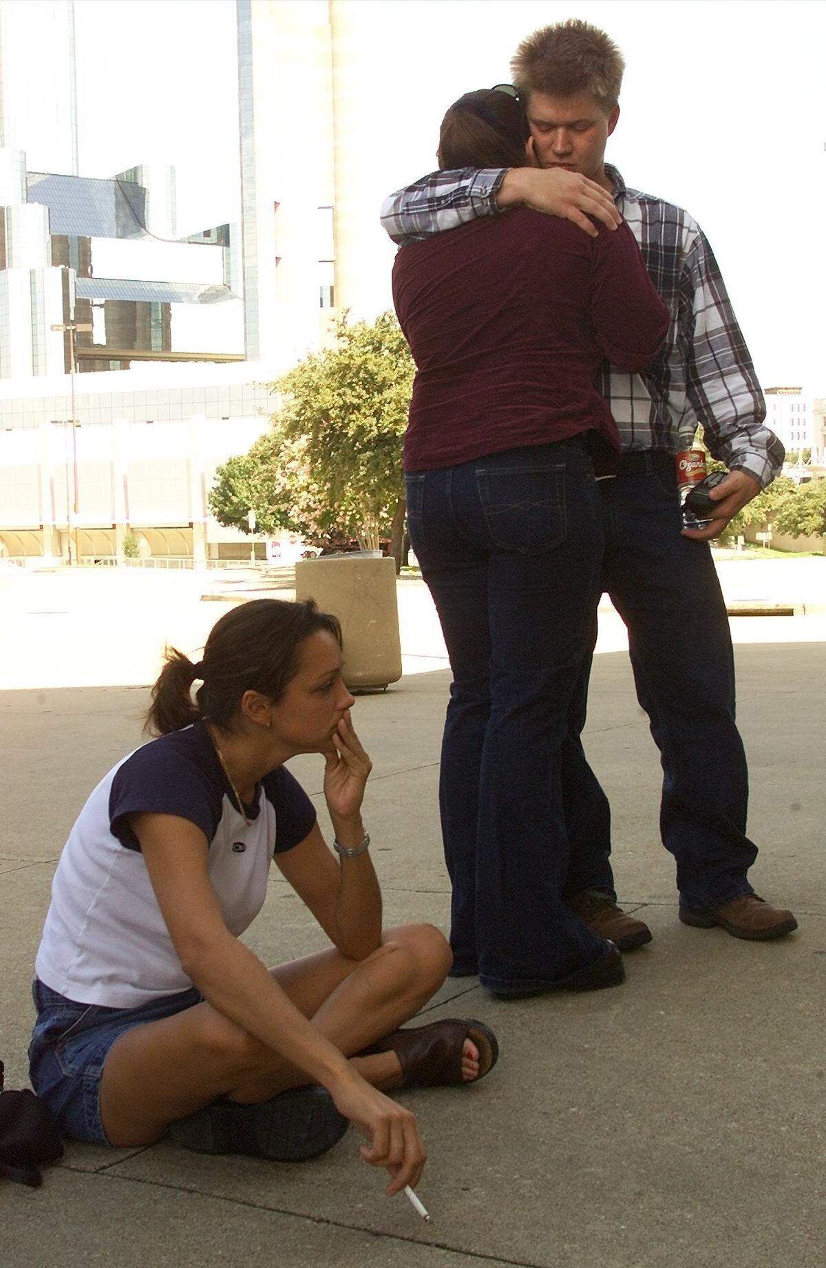 Madeleine Flanagan of Dallas sits and thinks while Teresa Bullard of California is comforted by her boyfriend Chris Johnston as they wait to give blood outside Reunion Arena on Sept. 11.