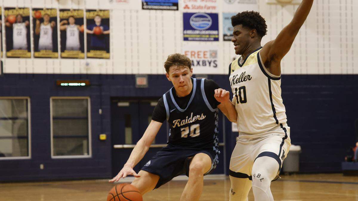 L.D. Bell forward Jesse Mikus (20) drives to the key defended by Keller forward Tyson Harris (10) during the first half of a UIL boys basketball game between L.D. Bell and Keller at Keller High School in Keller, Texas, Friday Jan. 16, 2026