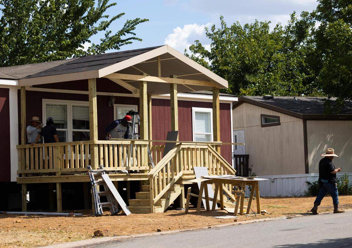 Crews build a porch on a manufactured home at Summit Oaks Homes in Fort Worth.