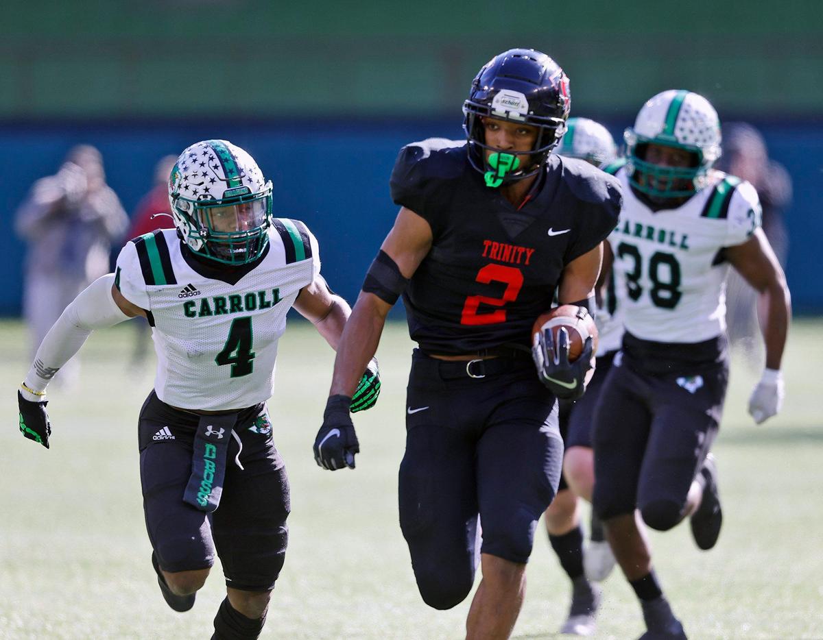 Trinity running back Ollie Gordon (2) outruns the defense of Southlake’s Cinque Williams during the 6A division 1 quarterfinals at Globe Life Park in Arlington, Texas, Saturday, Jan. 02, 2021. Southlake led Trinity 38-21 at the half. (Special to the Star-Telegram Bob Booth)