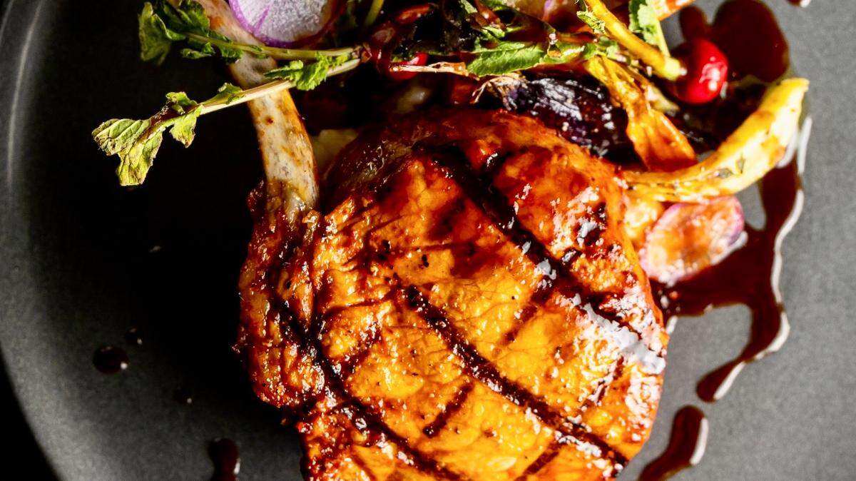 A pork chop with chili-adobo marinade is the feature on Toro Toro’s holiday menu.