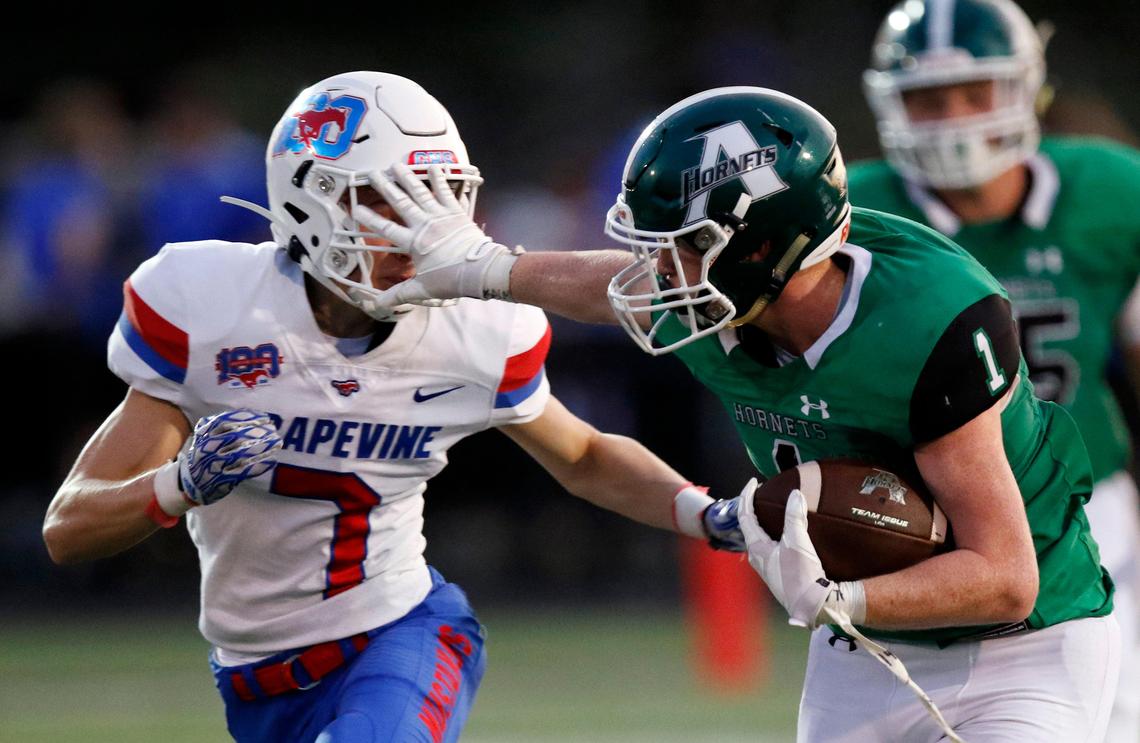 Azle’s Cullen Furr, right, applies a stiff arm to the face of Grapevine’s Jackson Cunningham in their meeting earlier this season won by the Mustangs 23-22. Azle avenged the defeat Friday, Nov. 15 with a 45-21 victory in a bi-district playoff game.