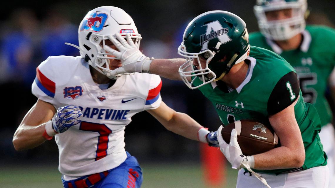 Azle’s Cullen Furr, right, applies a stiff arm to the face of Grapevine’s Jackson Cunningham in their meeting earlier this season won by the Mustangs 23-22. Azle avenged the defeat Friday, Nov. 15 with a 45-21 victory in a bi-district playoff game.