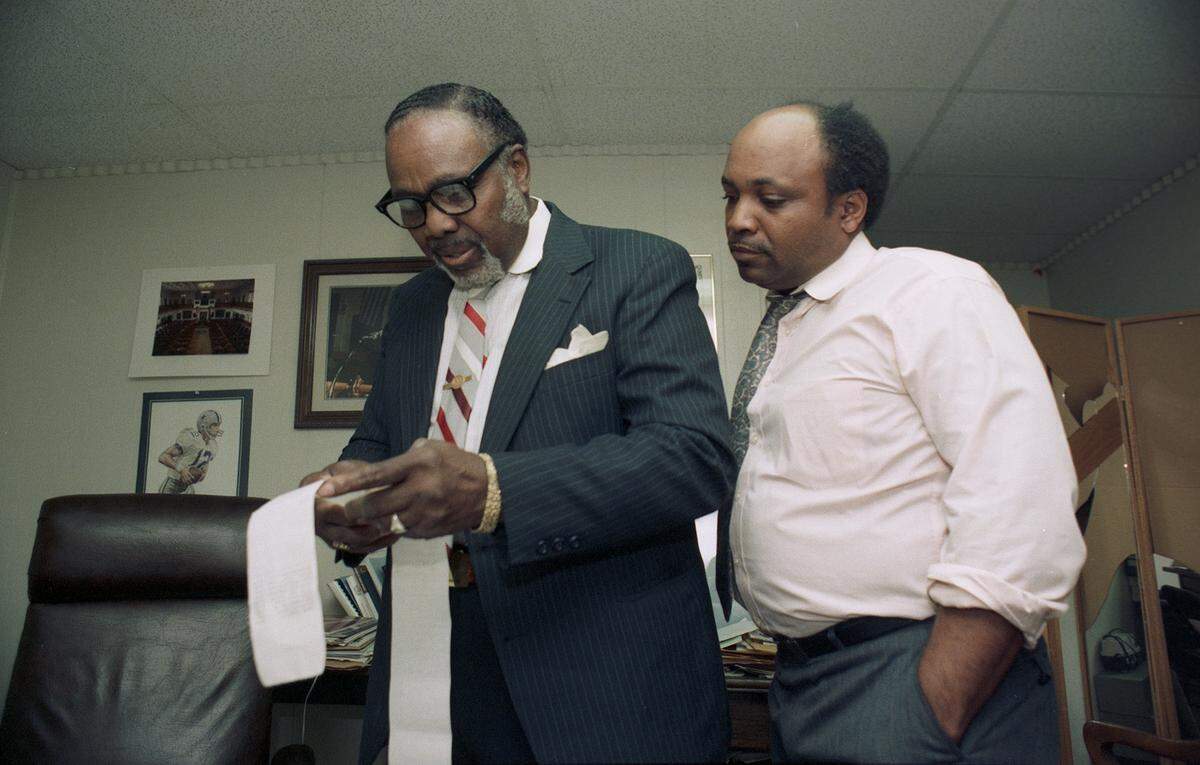 March 9, 1988: State Rep. Garfield Thompson, left, and his son Sidney checking election results on Super Tuesday.