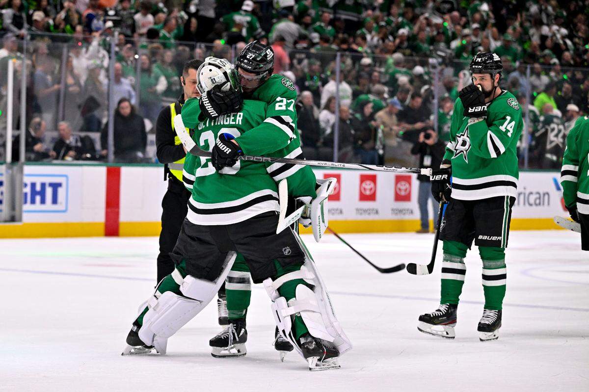 Dallas Stars goaltender Jake Oettinger (29) hugs left wing Mason Marchment (27) celebrate after the Stars defeat the Edmonton Oilers in game one of the Western Conference Final of the 2025 Stanley Cup Playoffs at American Airlines Center. Game 2 is Friday night.