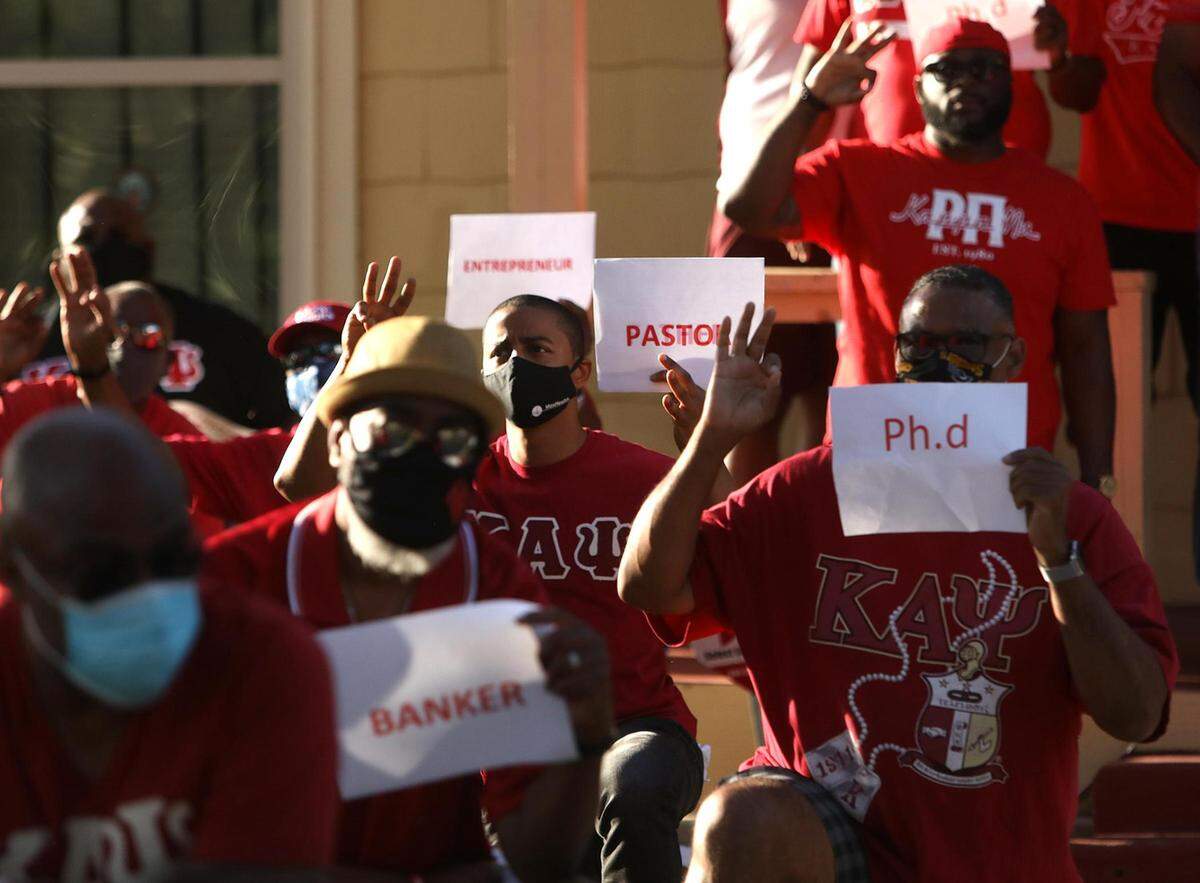 Members of the Fort Worth Alumni Chapter of Kappa Alpha Psi Fraternity take a knee with signs stating their professions on Tuesday, June 9, 2020, in Fort Worth. The group assembled to share their experiences and the fact that as black professionals they still experience police misconduct.