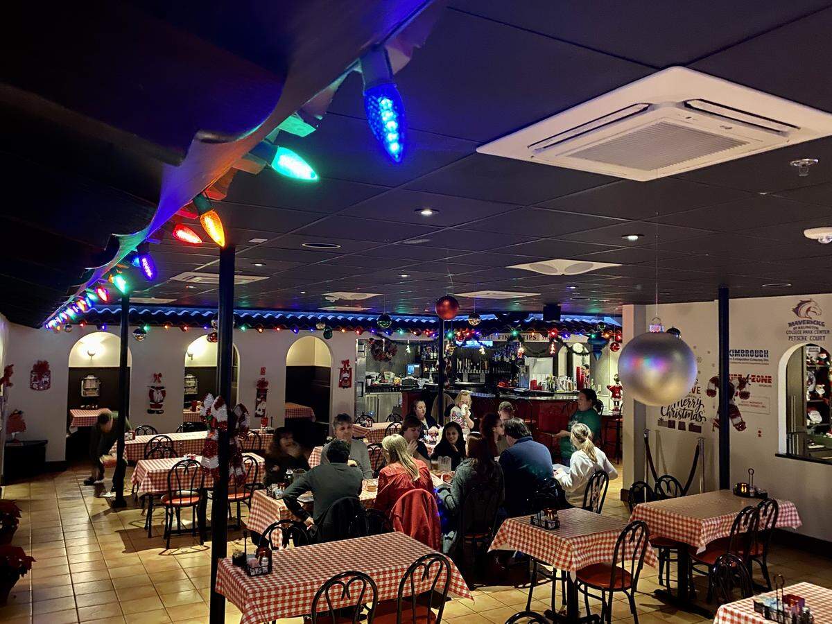 Candlelite Inn in Arlington, an old-time restaurant with booths, is decorated for Christmas.
