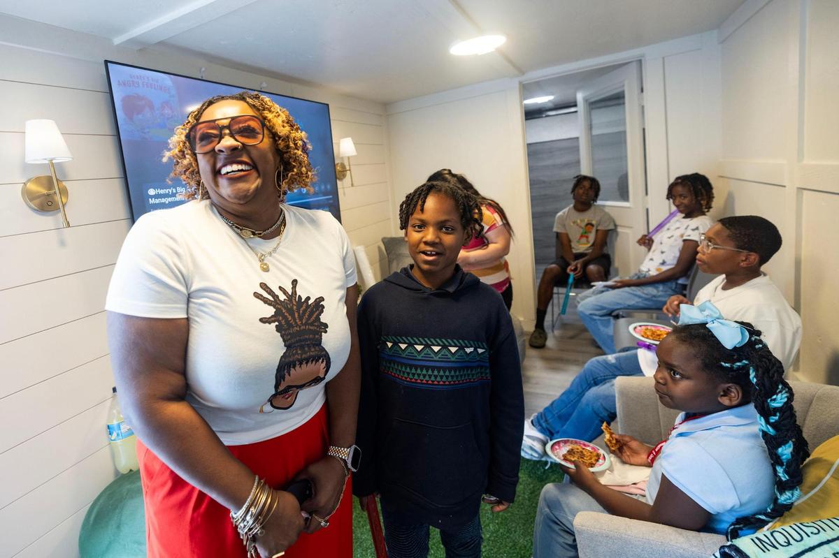 Lachelle Goodrich, the founder and executive director of CHAMP, does a personal space exercise with Anthony Richardson, 9, during a group therapy session at Rise Community Center.