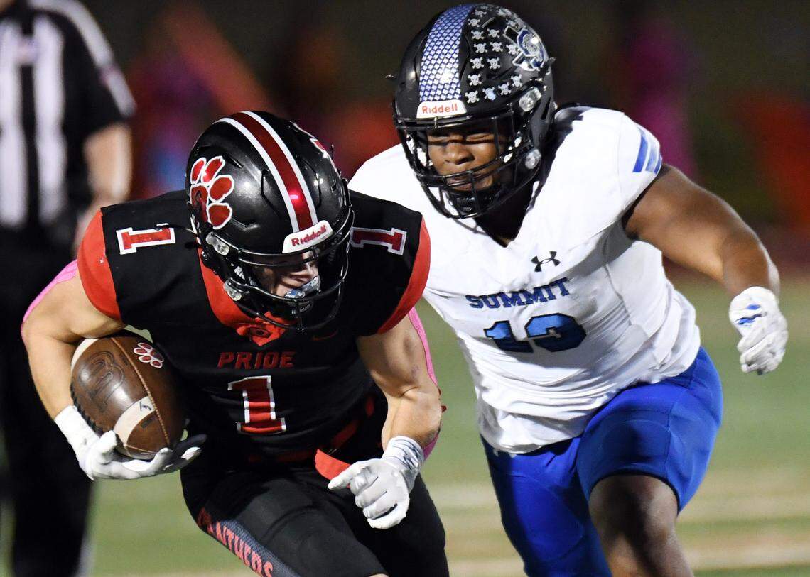 Colleyville Heritage’s Mason Murdock, left, makes a catch for a first down as he chased by Mansfield Summit’s Legend Journey in the second quarter of their district 4-5A Division 1 football game Friday, October 15, 2021 at Mustang-Panther Stadium in Grapevine, Texas. Heritage went on to win 35-34. Special/Bob Haynes