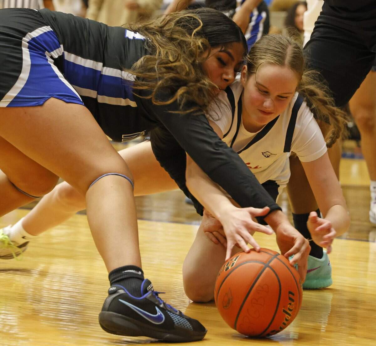 North Crowley forward Sandy Cortez (24) and Allen forward Katy Williams (22) fight for a loose ball during the second half of a UIL Class 6A Division I girls regional semifinals basketball playoff game at Grand Prairie High School in Grand Prairie, Texas, Tuesday Feb. 24, 2026.