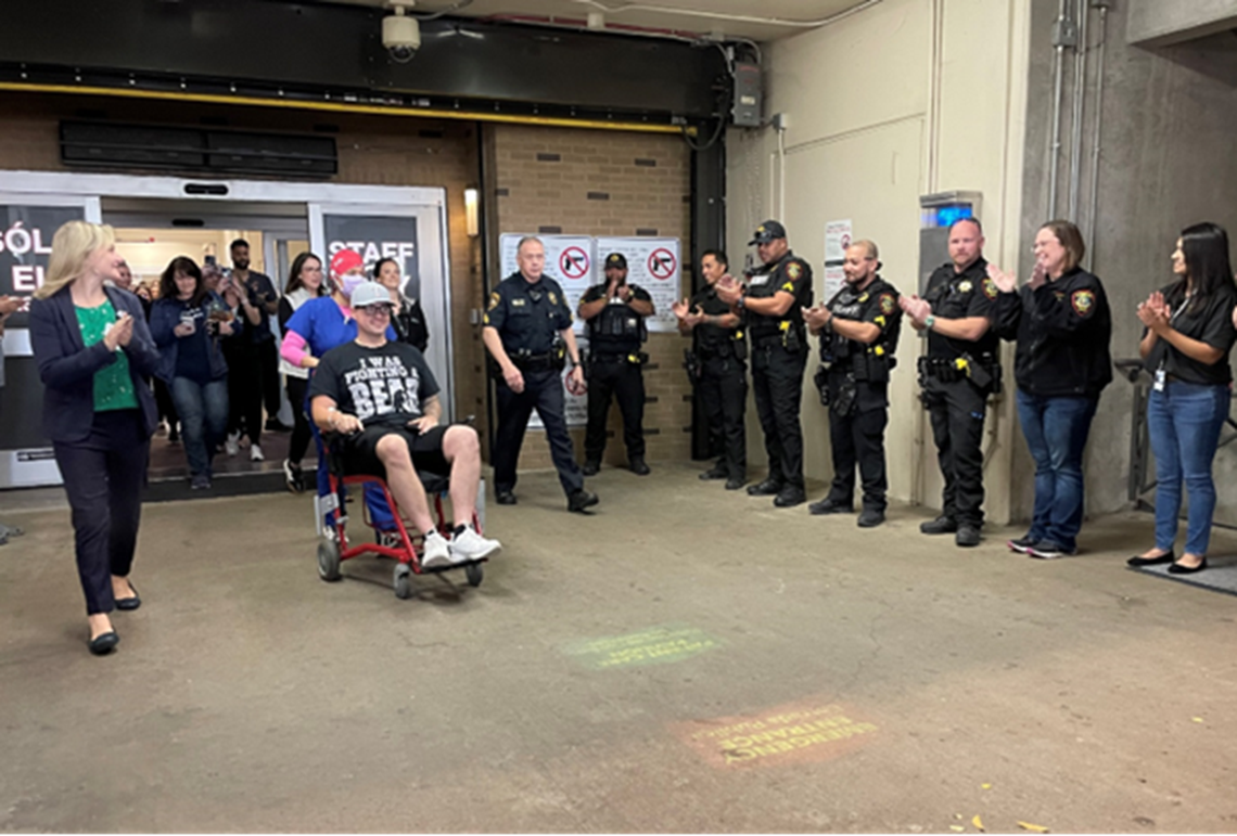 Tarrant County Sheriff’s Deputy Brent Brown, wearing a shirt that says, “I was fighting a bear,” was released from JPS Hospital on Friday, Dec. 8, 2023. Brown was wounded in a shootout with a gunman at a Fort Worth credit union on Nov. 27.
