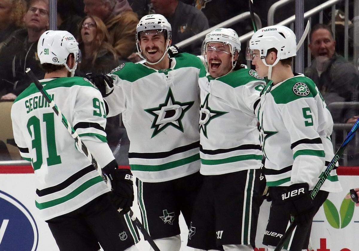 Dallas Stars center Tyler Seguin (91) and center Matt Duchene (RC) and defenseman Nils Lundkvist (5) congratulate left wing Mason Marchment (LC) on his goal against the Pittsburgh Penguins at PPG Paints Arena in Pittsburgh on Nov 11, 2024.