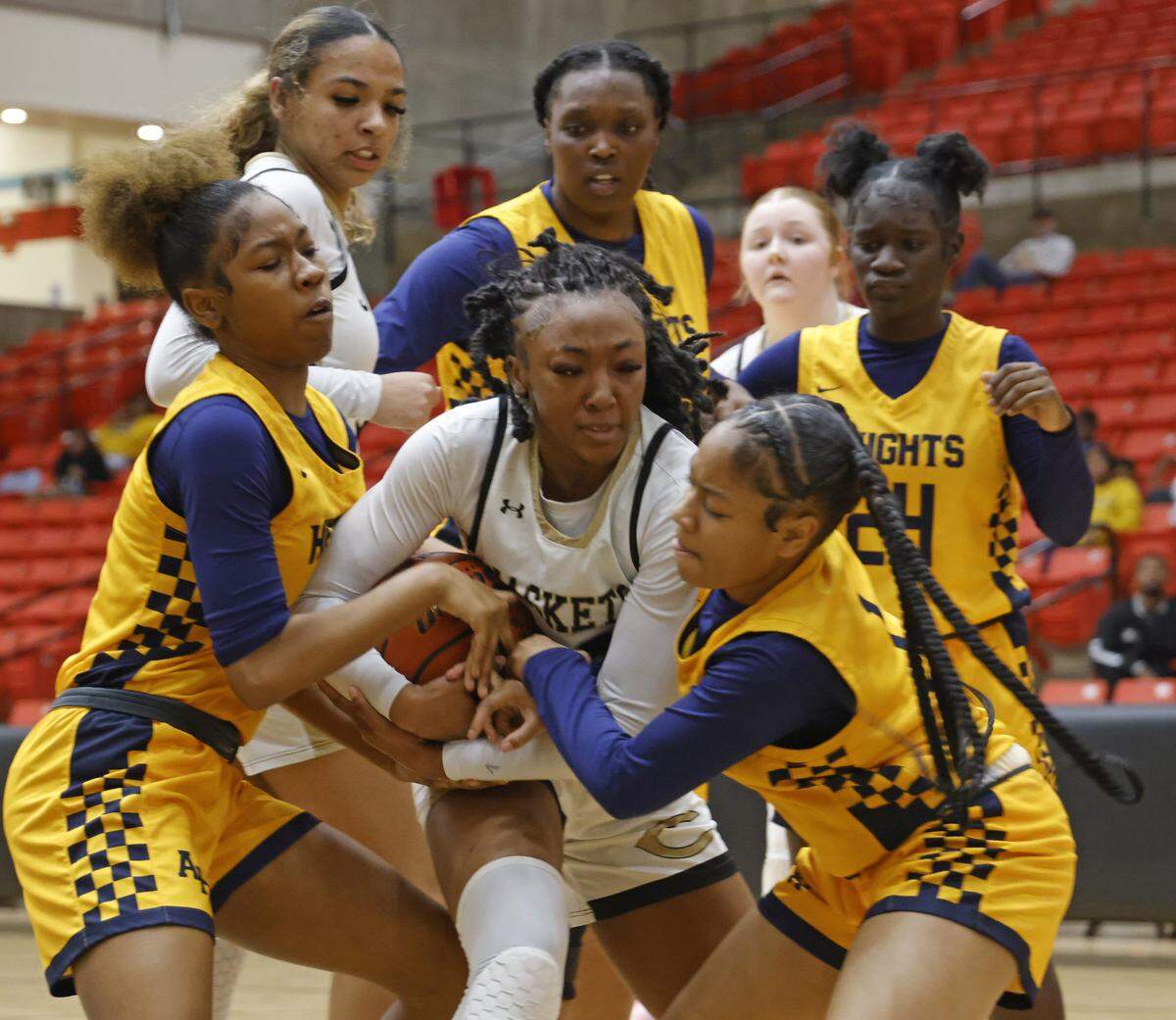 Arlington Heights guards Nyasia Washington (3) and Hope West (1) tie up Cleburne guard Arajai Burks (22) during the first half of the UIL 5A D1 girls bi-district championship basketball game at Wilkerson Greines Activity Center in Fort Worth, Texas, Monday Feb. 16, 2026.