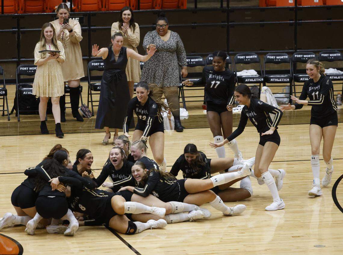 The Eagle Mountain Knights storm the court after sweeping Longview Spring Hill in three straight sets in their Class 4A Division II volleyball state semifinal Saturday at Wilkerson-Greines Activity Center in Fort Worth.